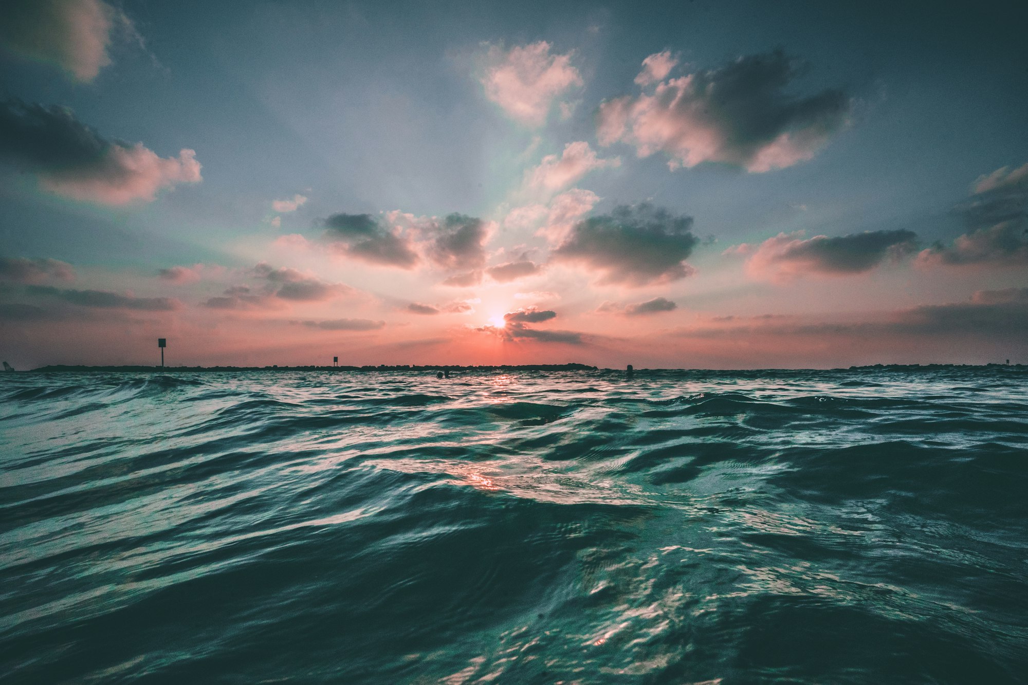 Choppy ocean water at sunset with waves rolling towards shore